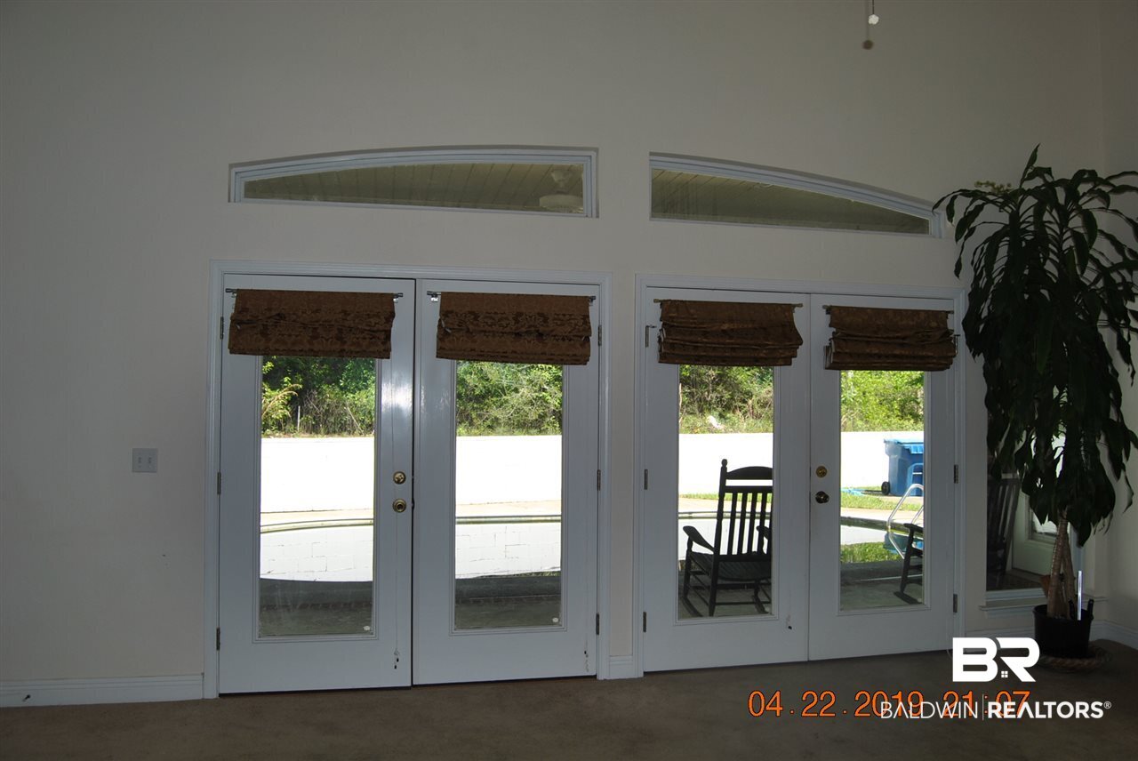 411 Juniper Creek Road Brewton, AL 36426 - Photo 14 of 35 Wall of windows view from den to patio, pool