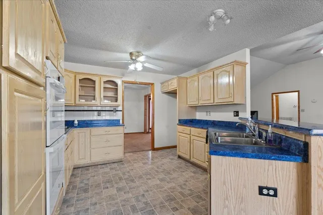 a kitchen with stainless steel appliances granite countertop a stove and a refrigerator