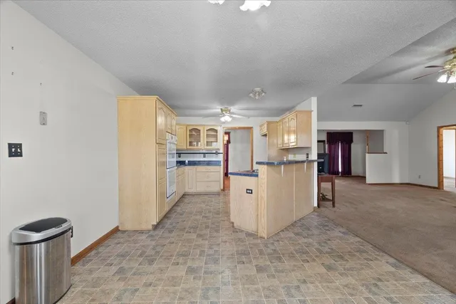 a view of kitchen and refrigerator