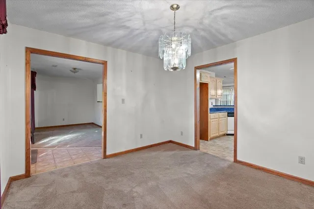 a view of a chandelier in big room and a chandelier