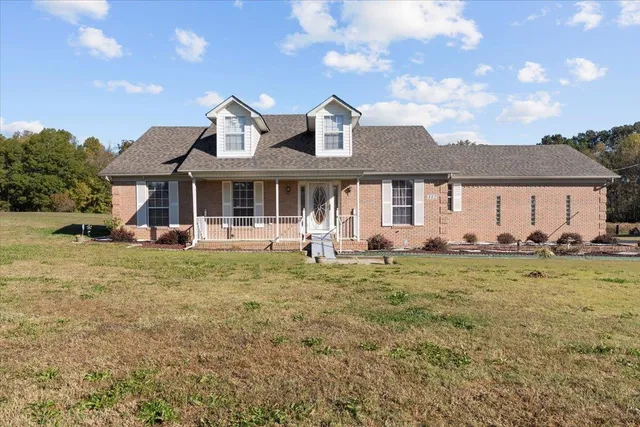 a view of a house with backyard porch and furniture