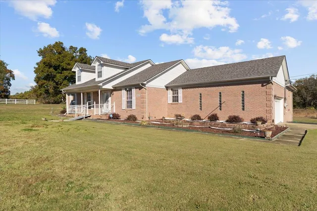 a view of a house with backyard porch and furniture