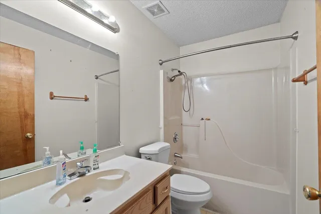 a bathroom with a sink toilet vanity and shower