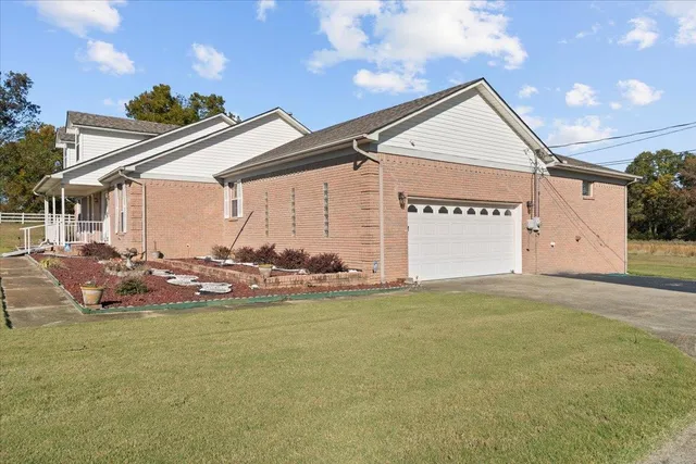 a view of a house with backyard and sitting area