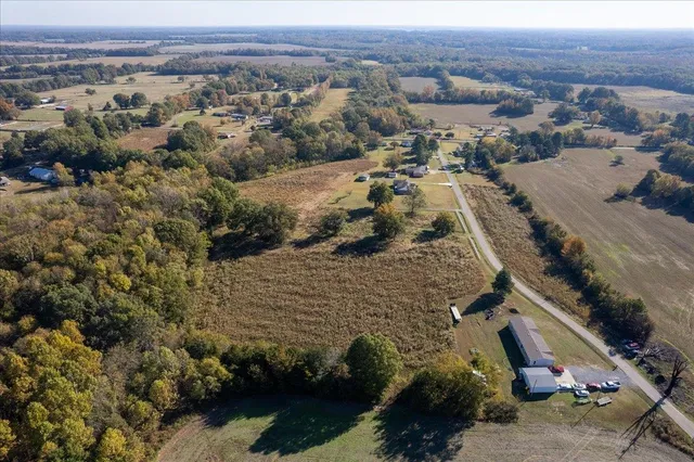 an aerial view of a house with a yard