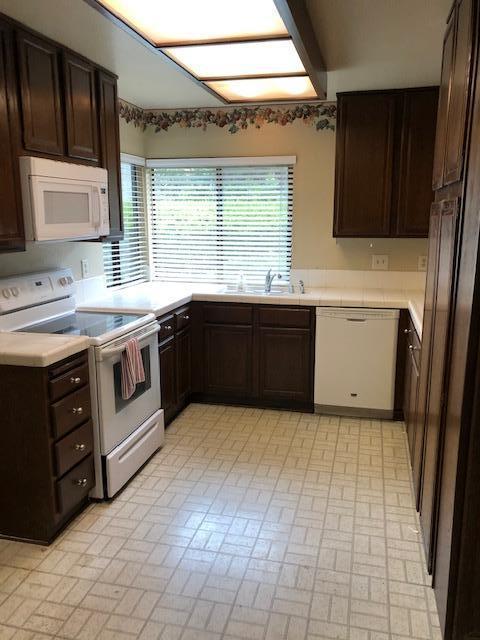 1095 Old Ranch Road Camarillo, CA 93012 - Photo 6 of 12 a large kitchen with stainless steel appliances granite countertop a stove a sink and a microwave