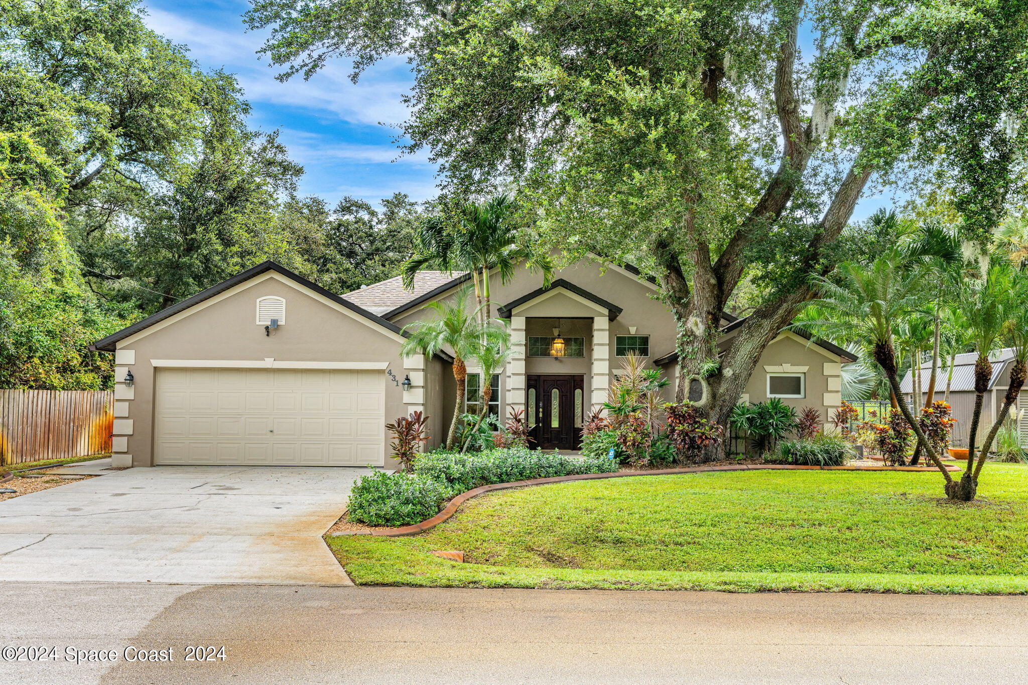 431 Nina Road Northeast Palm Bay, FL 32907 - Photo 1 of 41 a front view of a house with a yard and garage