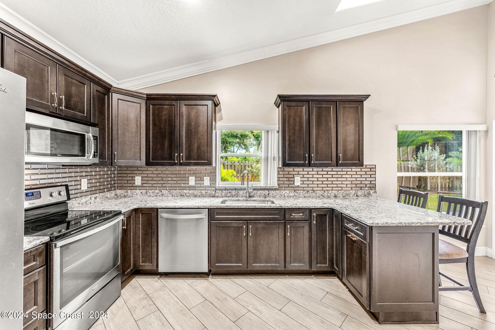 431 Nina Road Northeast Palm Bay, FL 32907 - Photo 11 of 41 a kitchen with stainless steel appliances granite countertop a stove sink and cabinets