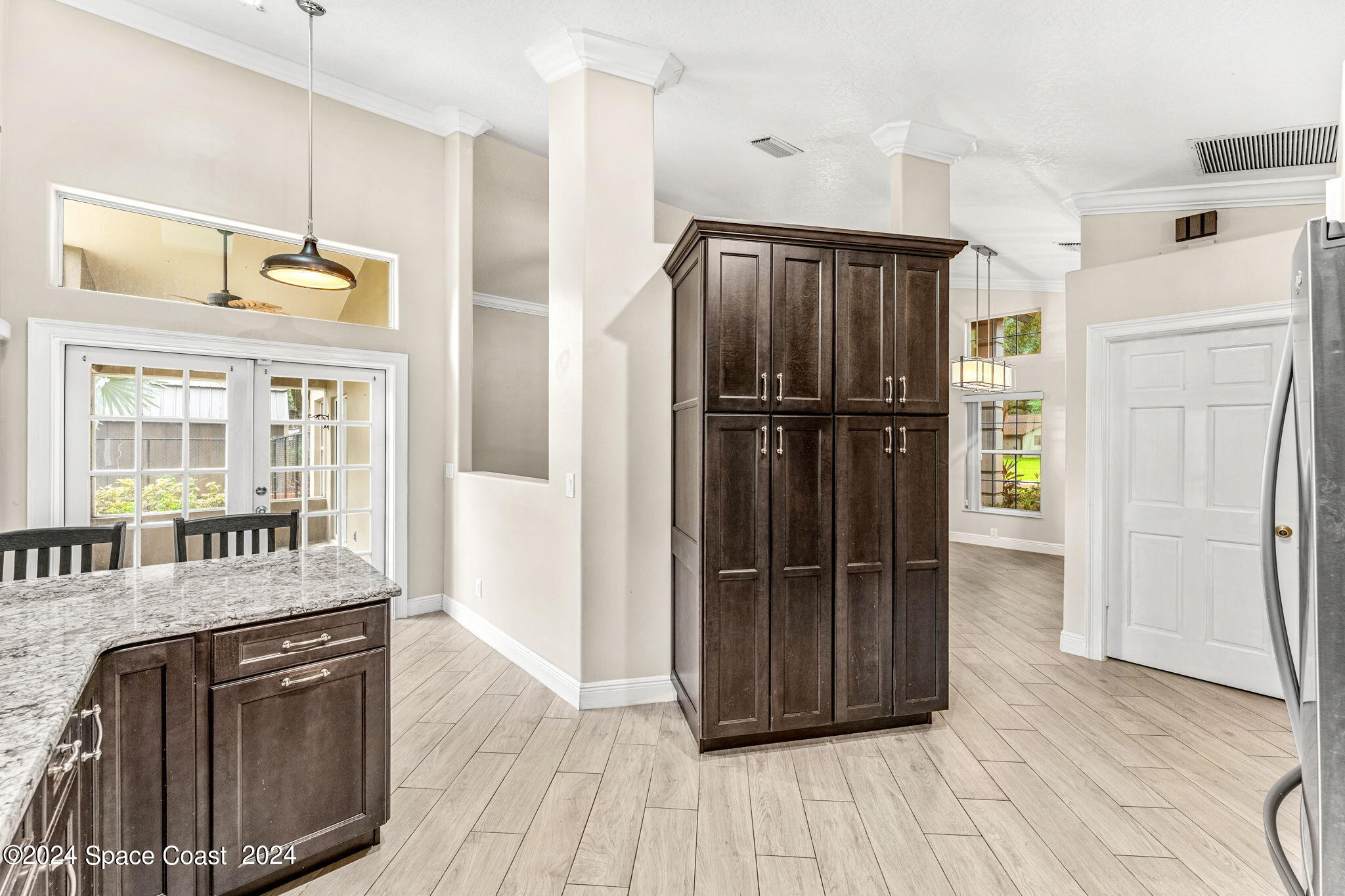 431 Nina Road Northeast Palm Bay, FL 32907 - Photo 12 of 41 a kitchen with stainless steel appliances a refrigerator and wooden floor