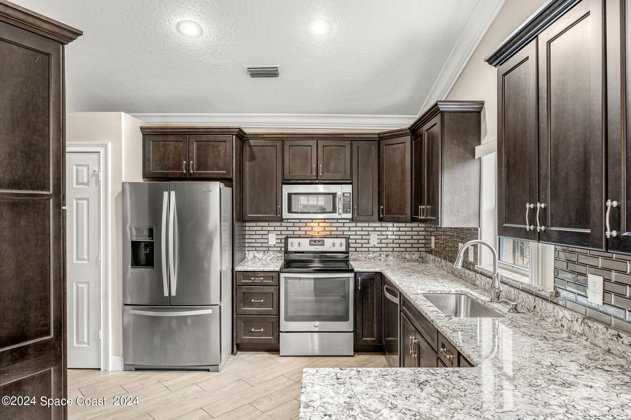 431 Nina Road Northeast Palm Bay, FL 32907 - Photo 13 of 41 a kitchen with stainless steel appliances granite countertop a refrigerator and a sink