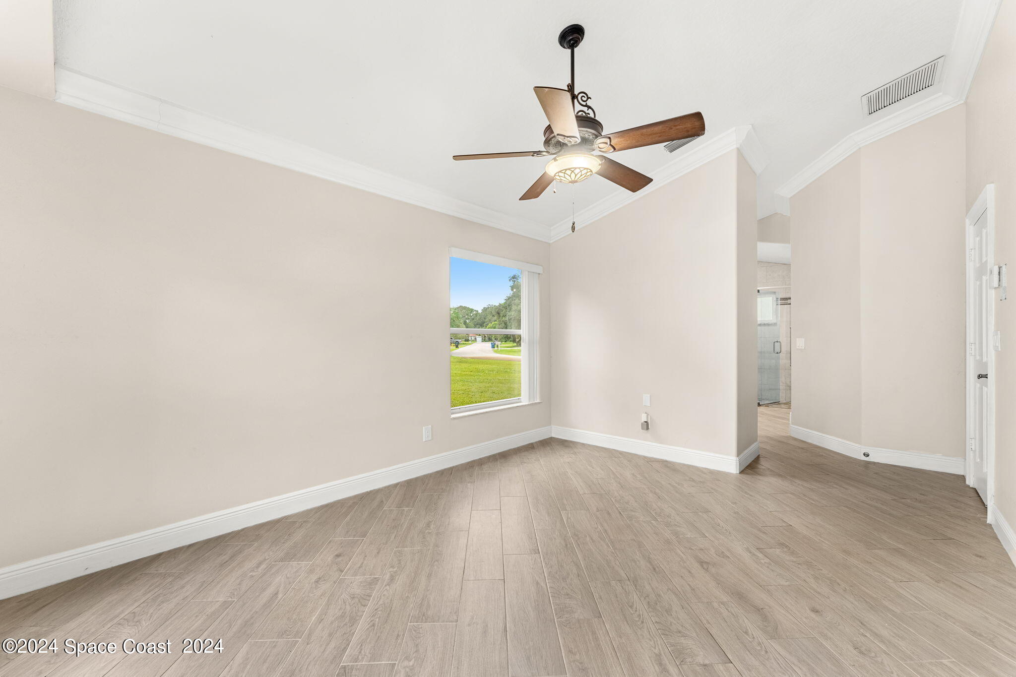 431 Nina Road Northeast Palm Bay, FL 32907 - Photo 16 of 41 an empty room with a window and a ceiling fan