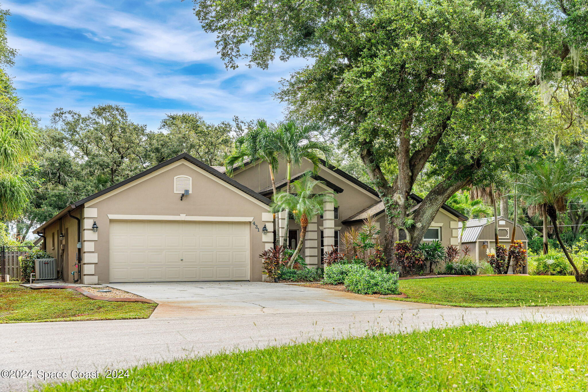 431 Nina Road Northeast Palm Bay, FL 32907 - Photo 2 of 41 a front view of a house with a yard and trees