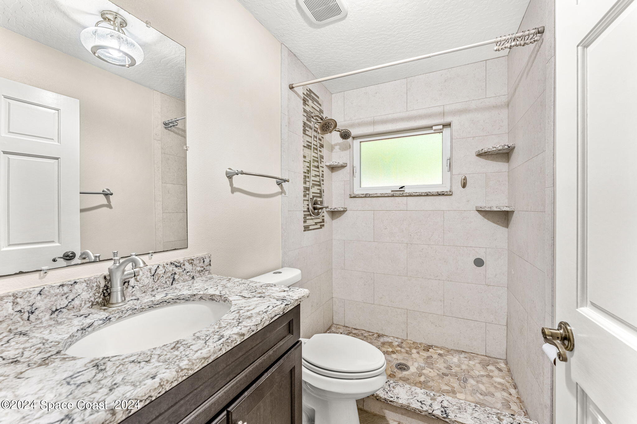 431 Nina Road Northeast Palm Bay, FL 32907 - Photo 21 of 41 a bathroom with a granite countertop sink toilet and shower