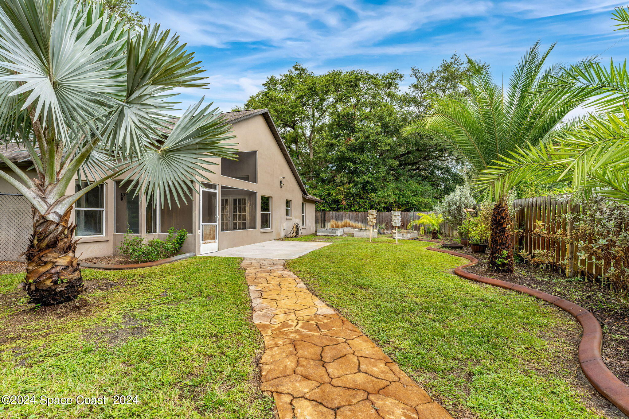 431 Nina Road Northeast Palm Bay, FL 32907 - Photo 24 of 41 a front view of a house with garden