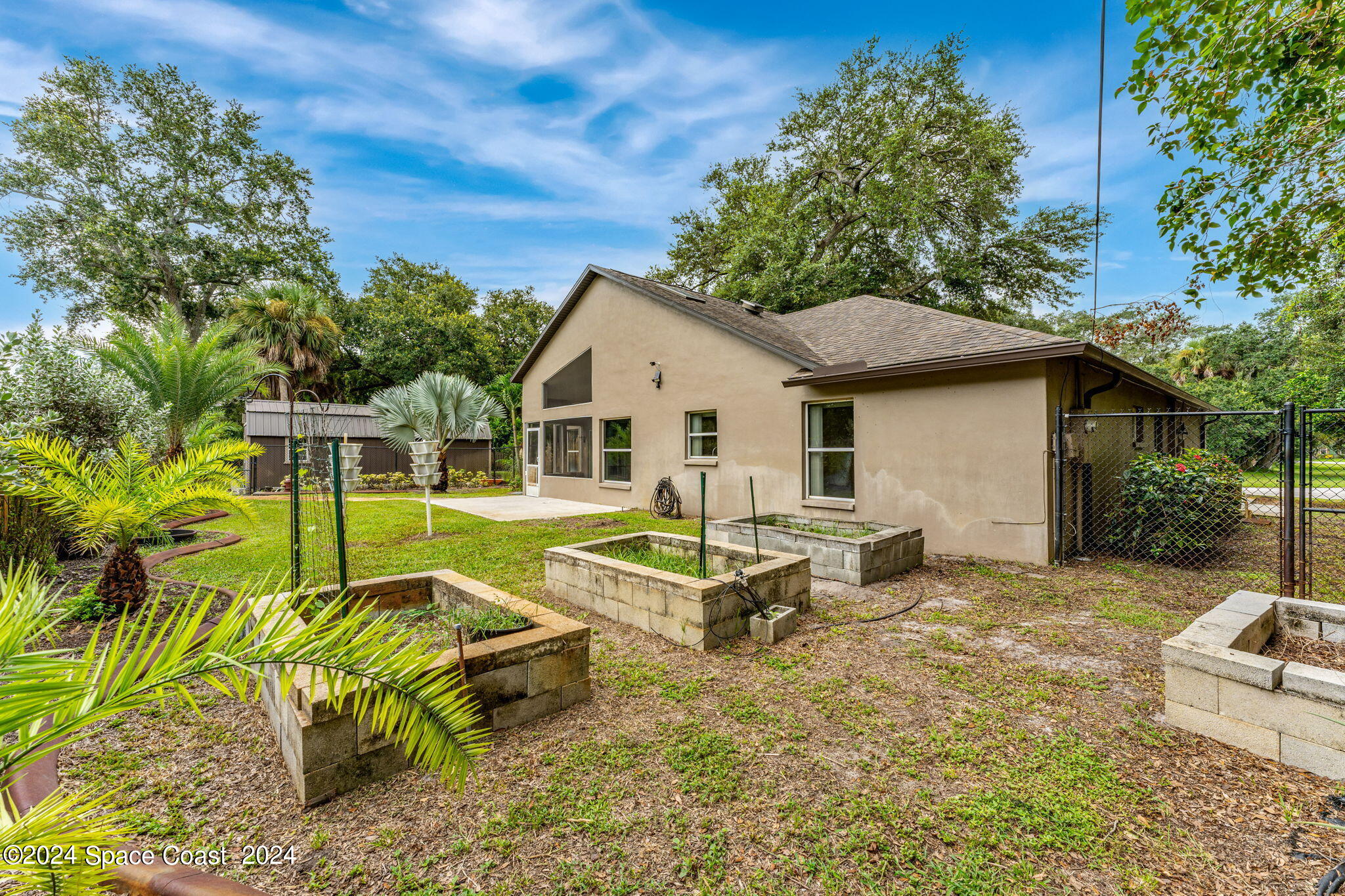 431 Nina Road Northeast Palm Bay, FL 32907 - Photo 25 of 41 a white bench sitting in front of a house