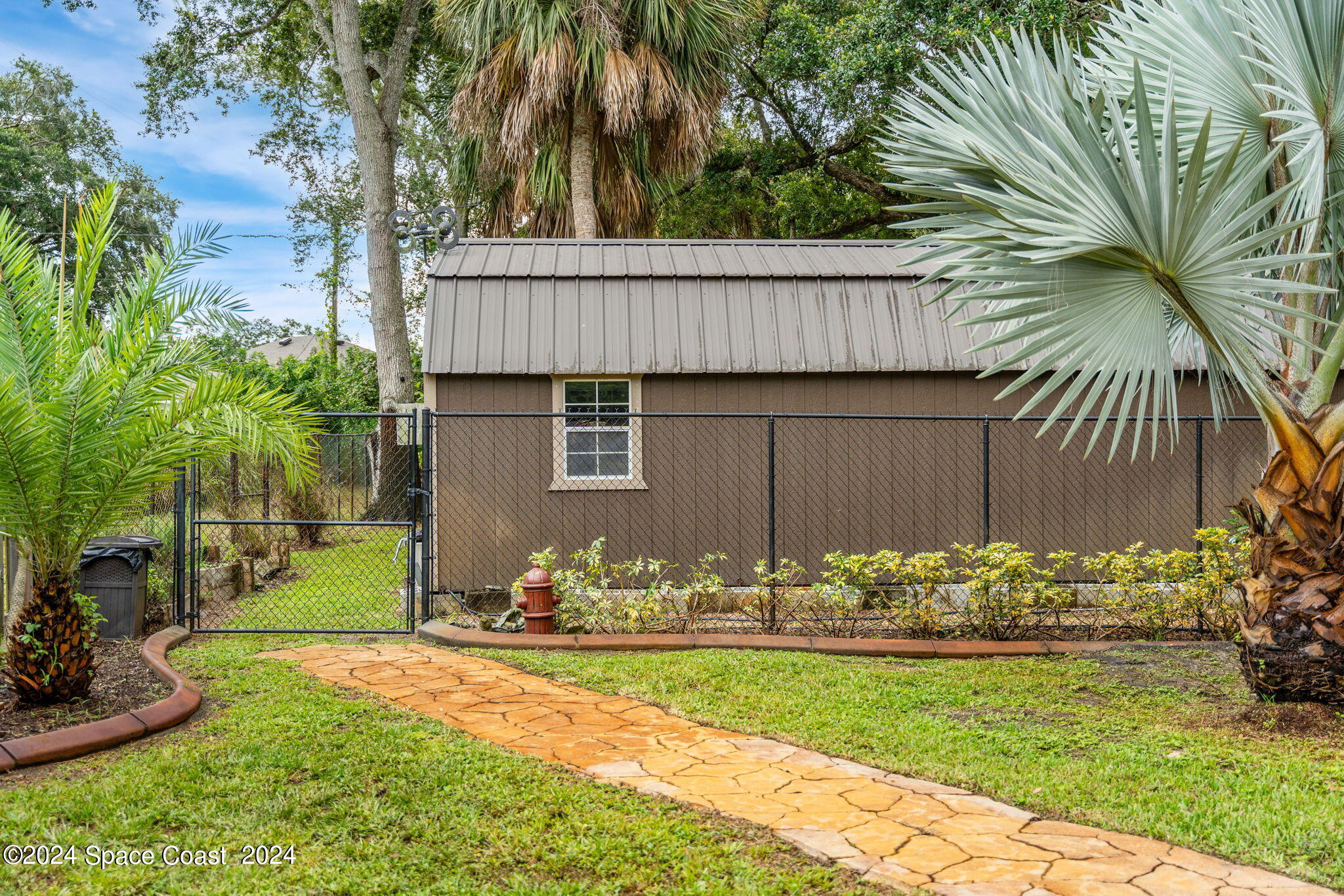 431 Nina Road Northeast Palm Bay, FL 32907 - Photo 26 of 41 a view of a backyard with potted plants