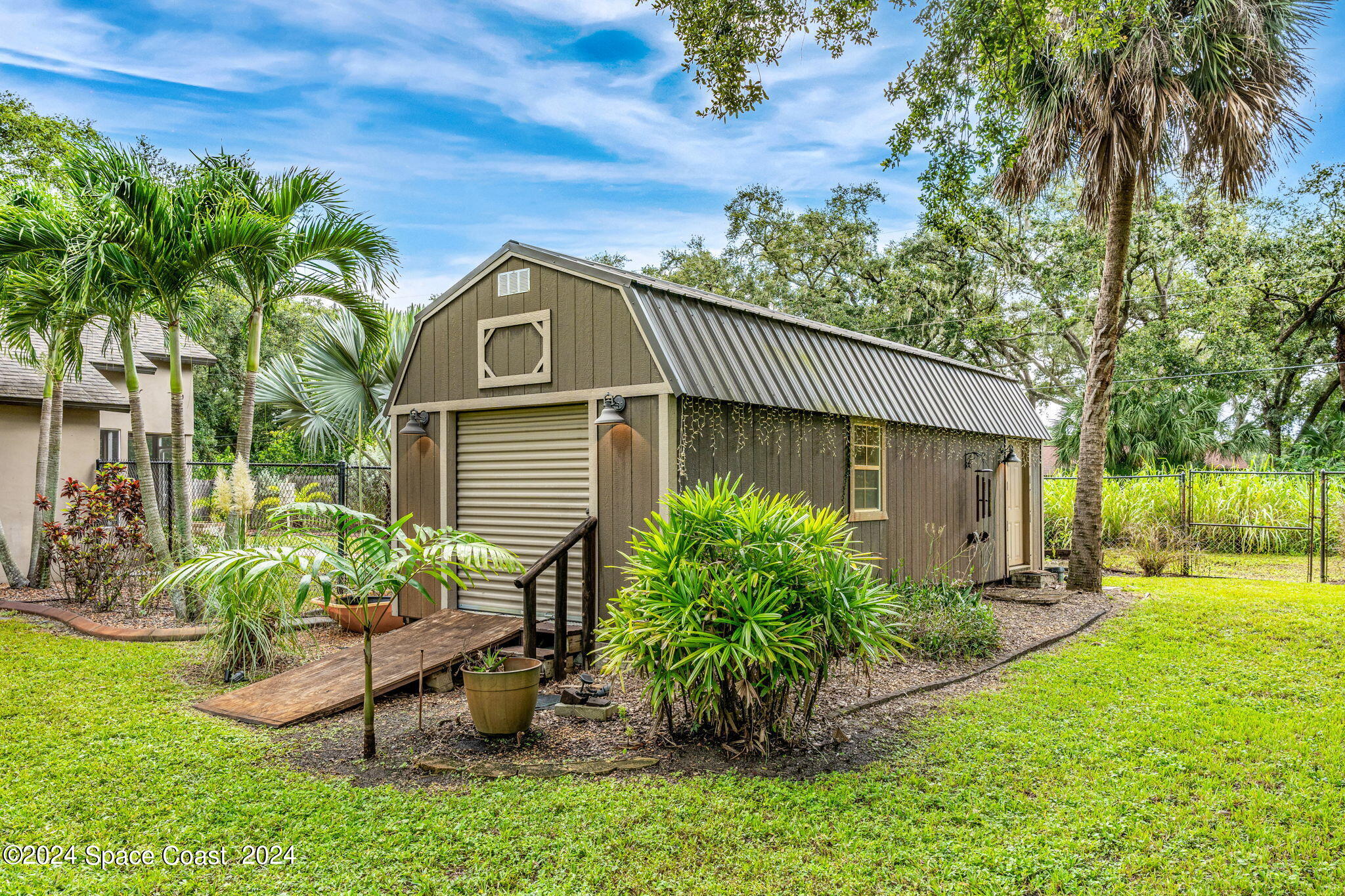 431 Nina Road Northeast Palm Bay, FL 32907 - Photo 27 of 41 a front view of a house with a yard
