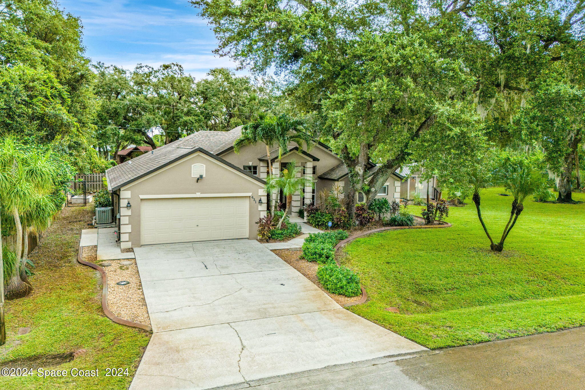 431 Nina Road Northeast Palm Bay, FL 32907 - Photo 3 of 41 a view of backyard of house along with trees