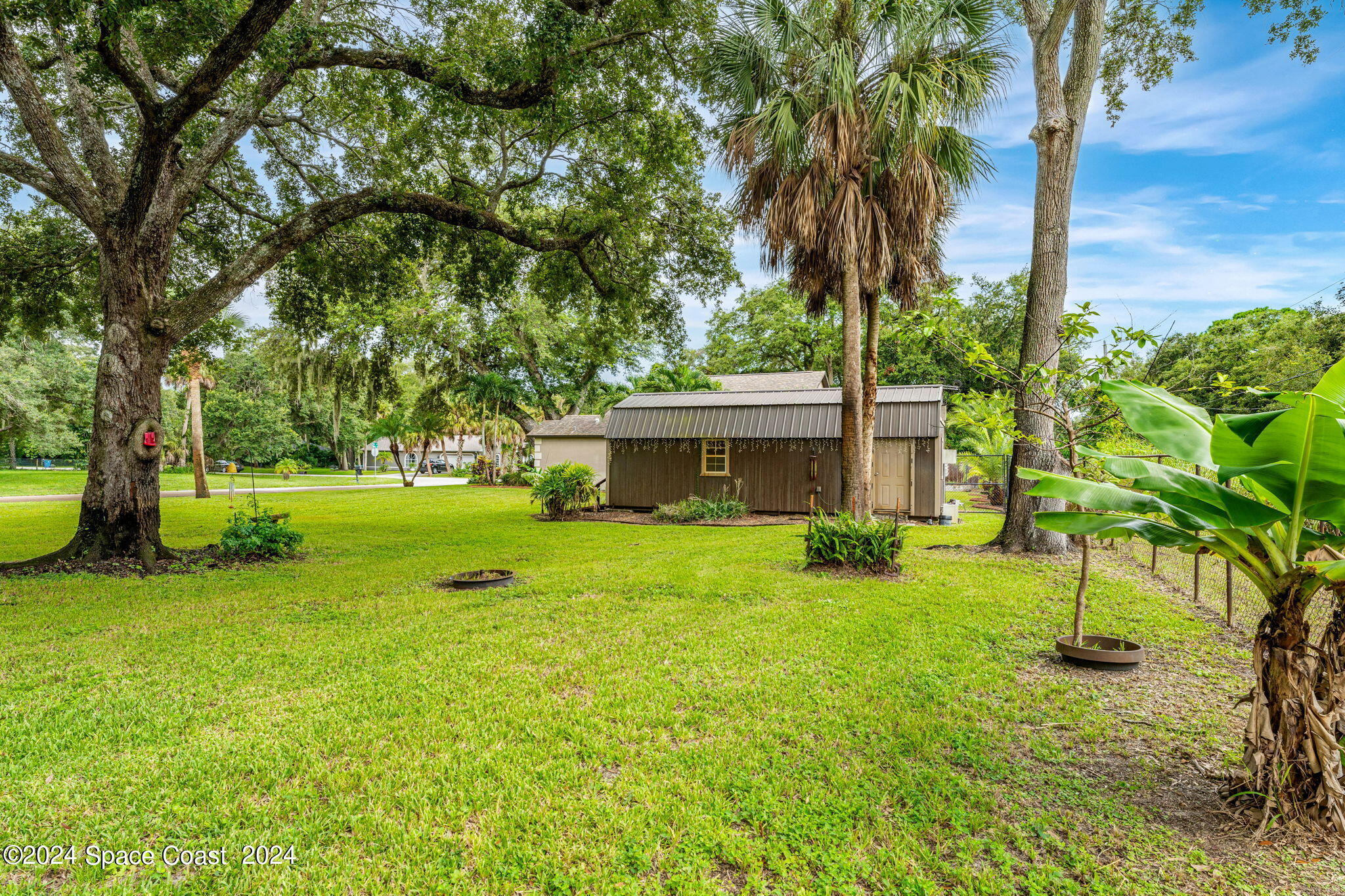 431 Nina Road Northeast Palm Bay, FL 32907 - Photo 32 of 41 a view of an house with backyard space and garden