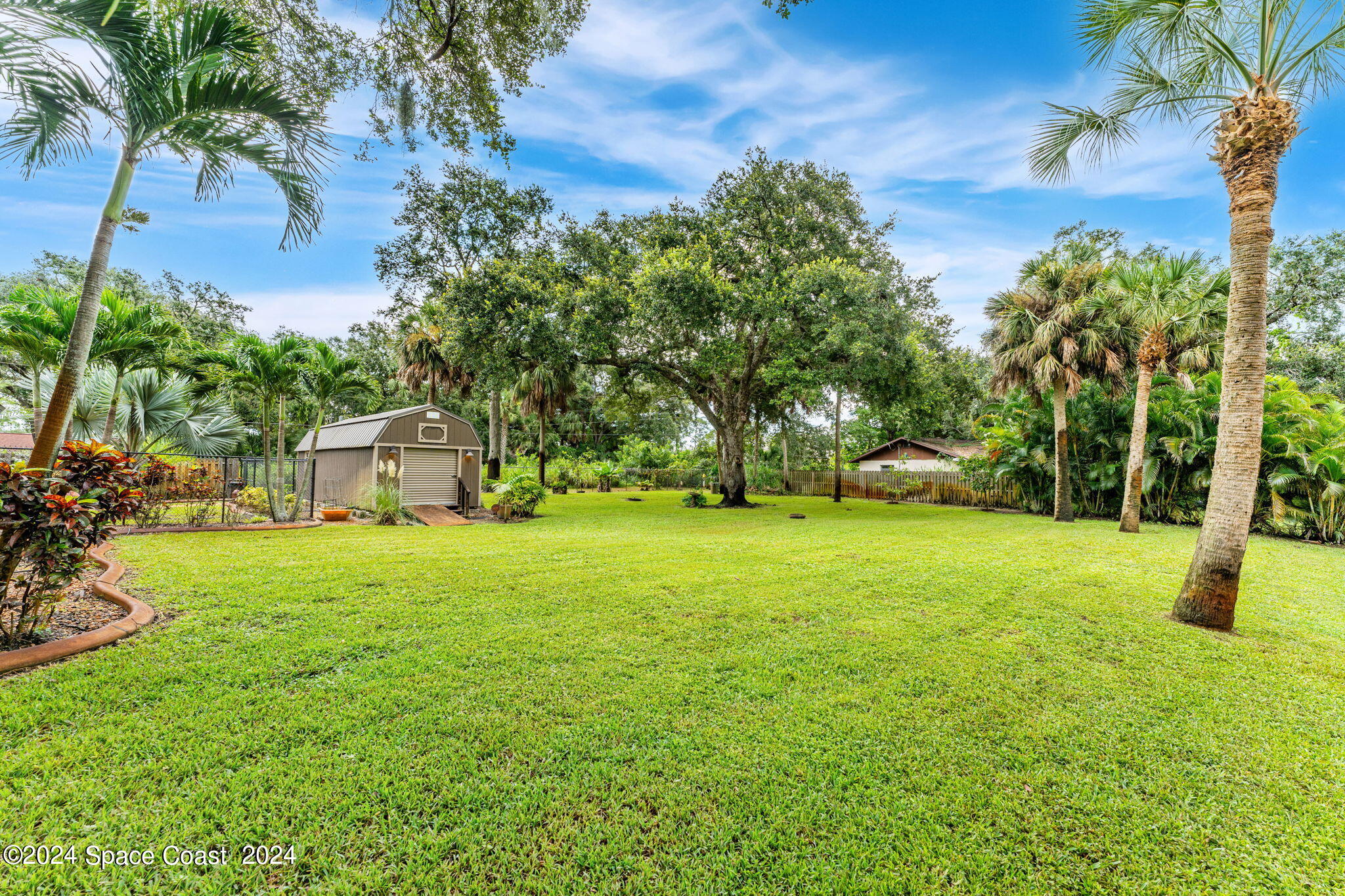 431 Nina Road Northeast Palm Bay, FL 32907 - Photo 34 of 41 a view of a trees and barn in the back yard