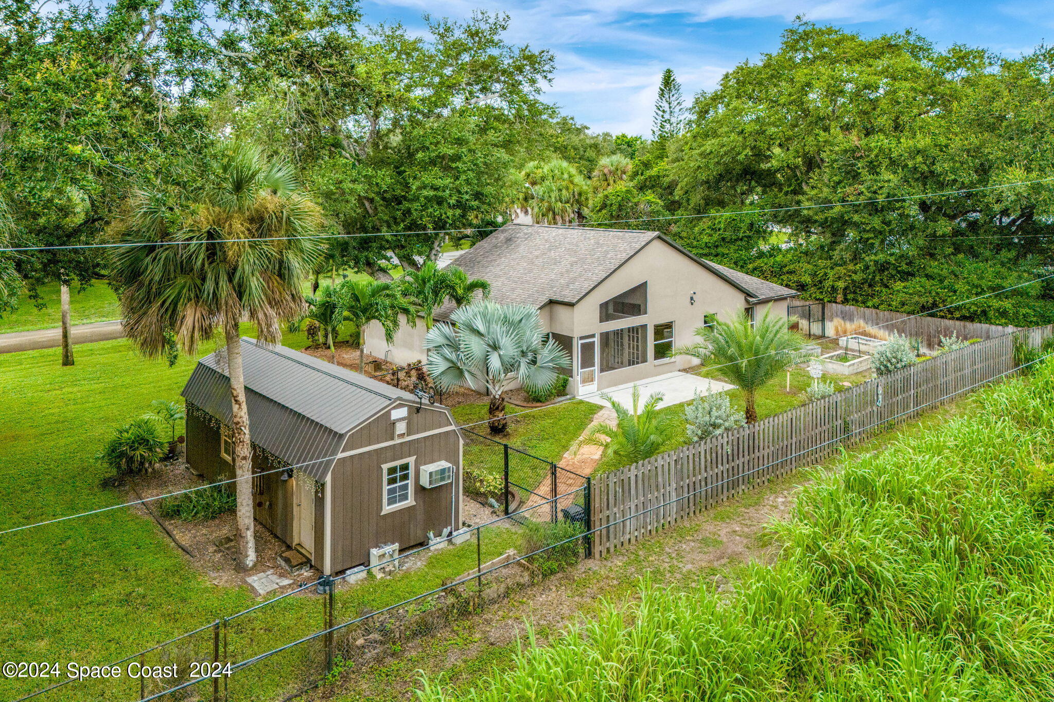 431 Nina Road Northeast Palm Bay, FL 32907 - Photo 40 of 41 a house with trees in the background