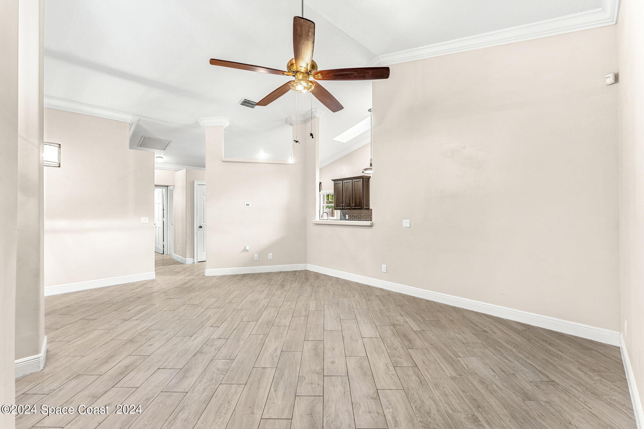 431 Nina Road Northeast Palm Bay, FL 32907 - Photo 6 of 41 a view of empty room with wooden floor and fan