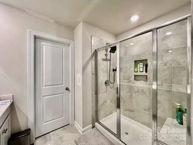 a bathroom with a glass shower door
