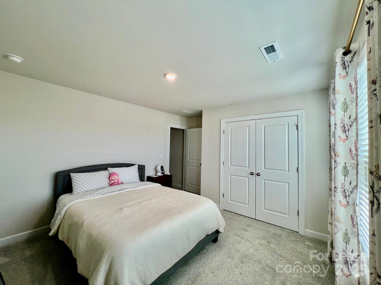 11509 Corleone Street Huntersville, NC 28078 - Photo 13 of 21 a spacious bedroom with a bed and a shower