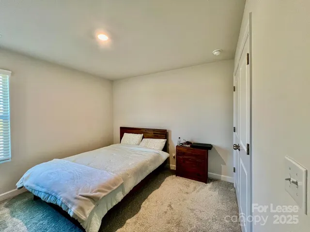 a bedroom with a bed and cabinets