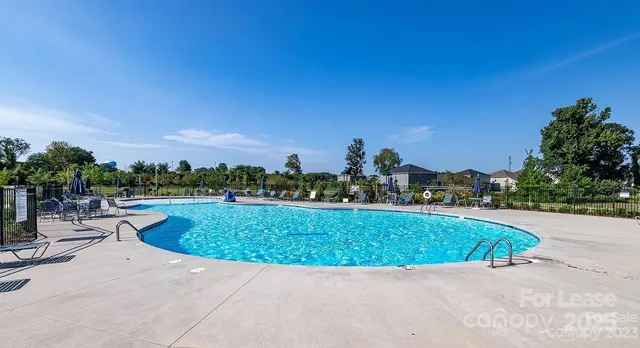 a view of a swimming pool and a yard