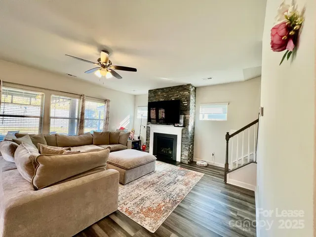 a living room with furniture fireplace and flat screen tv