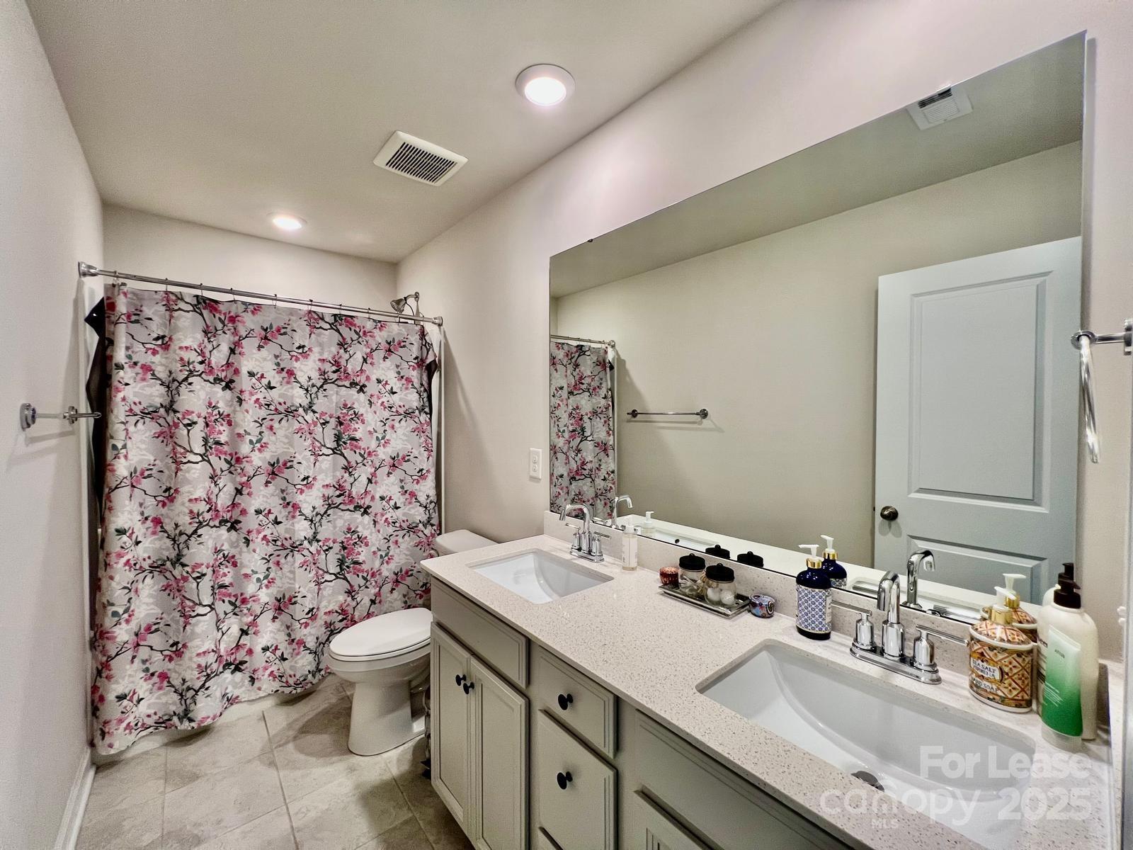 11509 Corleone Street Huntersville, NC 28078 - Photo 4 of 21 a bathroom with a double vanity sink mirror and toilet