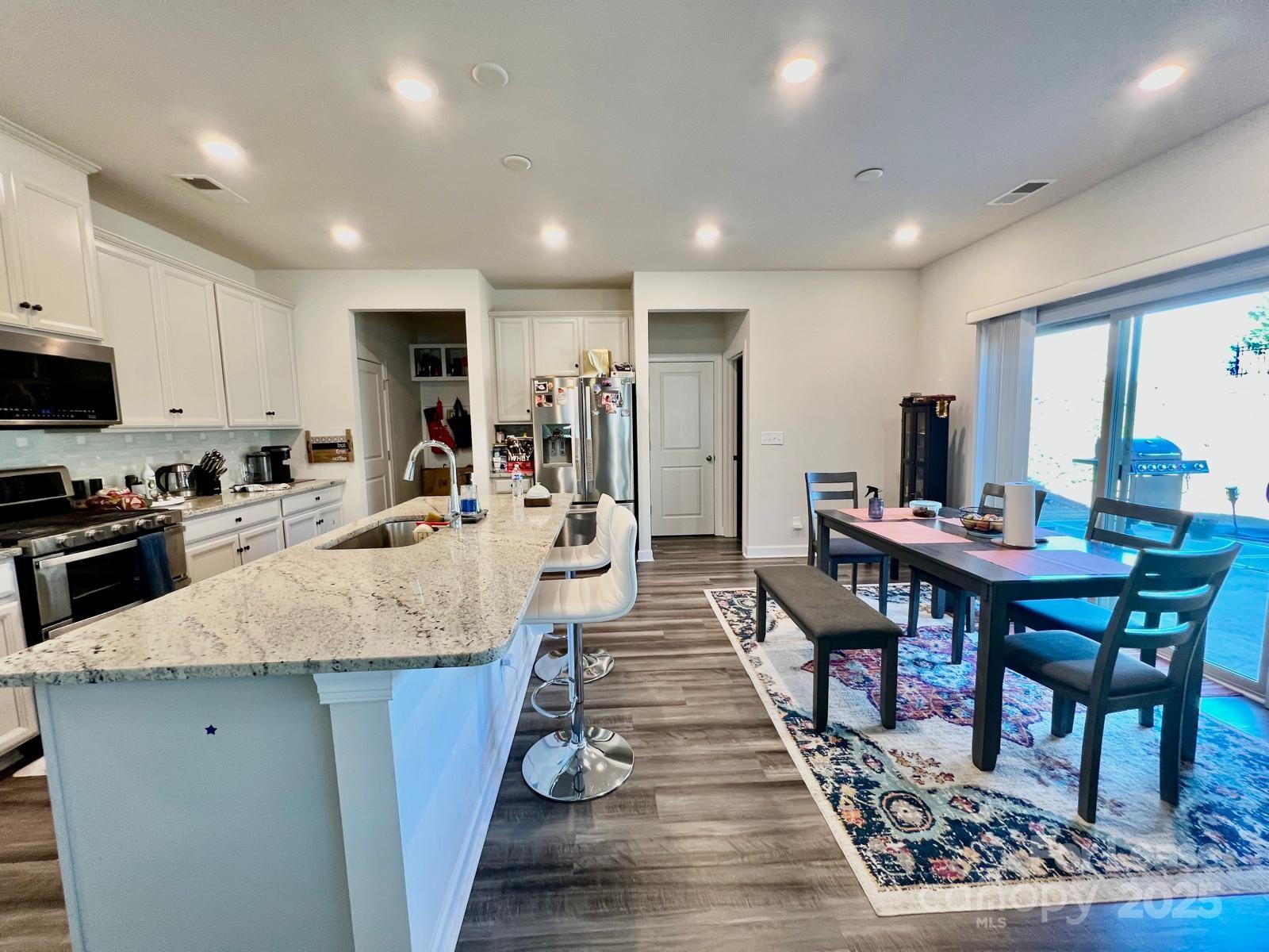 11509 Corleone Street Huntersville, NC 28078 - Photo 5 of 21 a large kitchen with lots of table and chairs