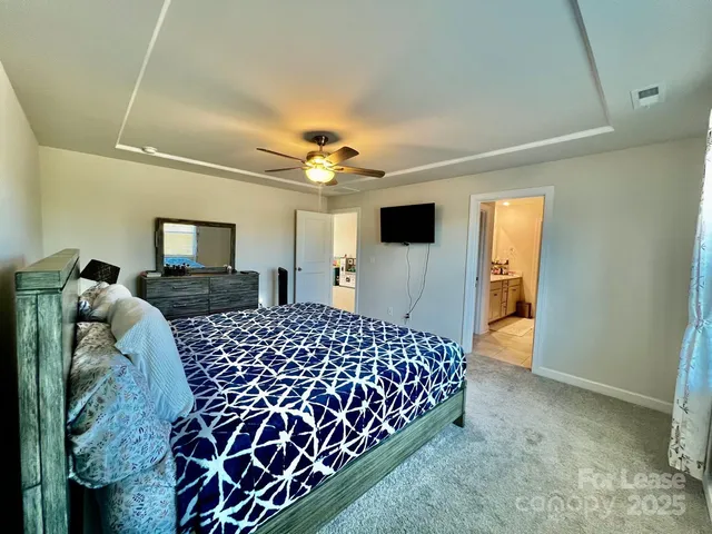 a bedroom with a bed and mirror