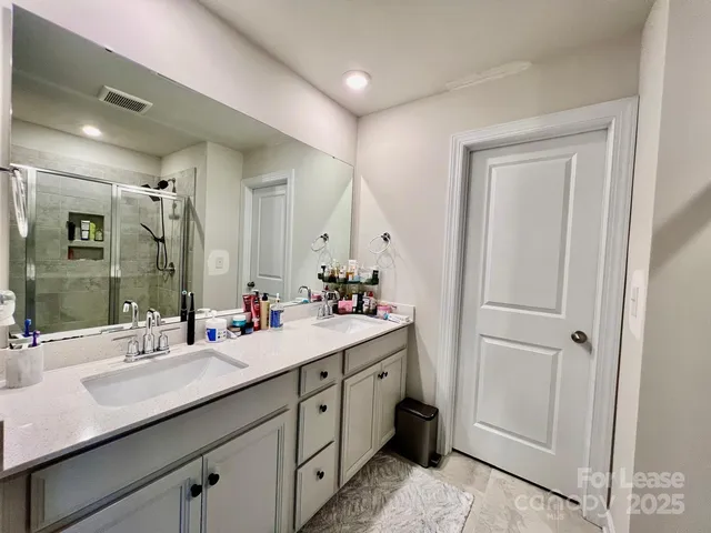 a bathroom with a double vanity sink mirror and double