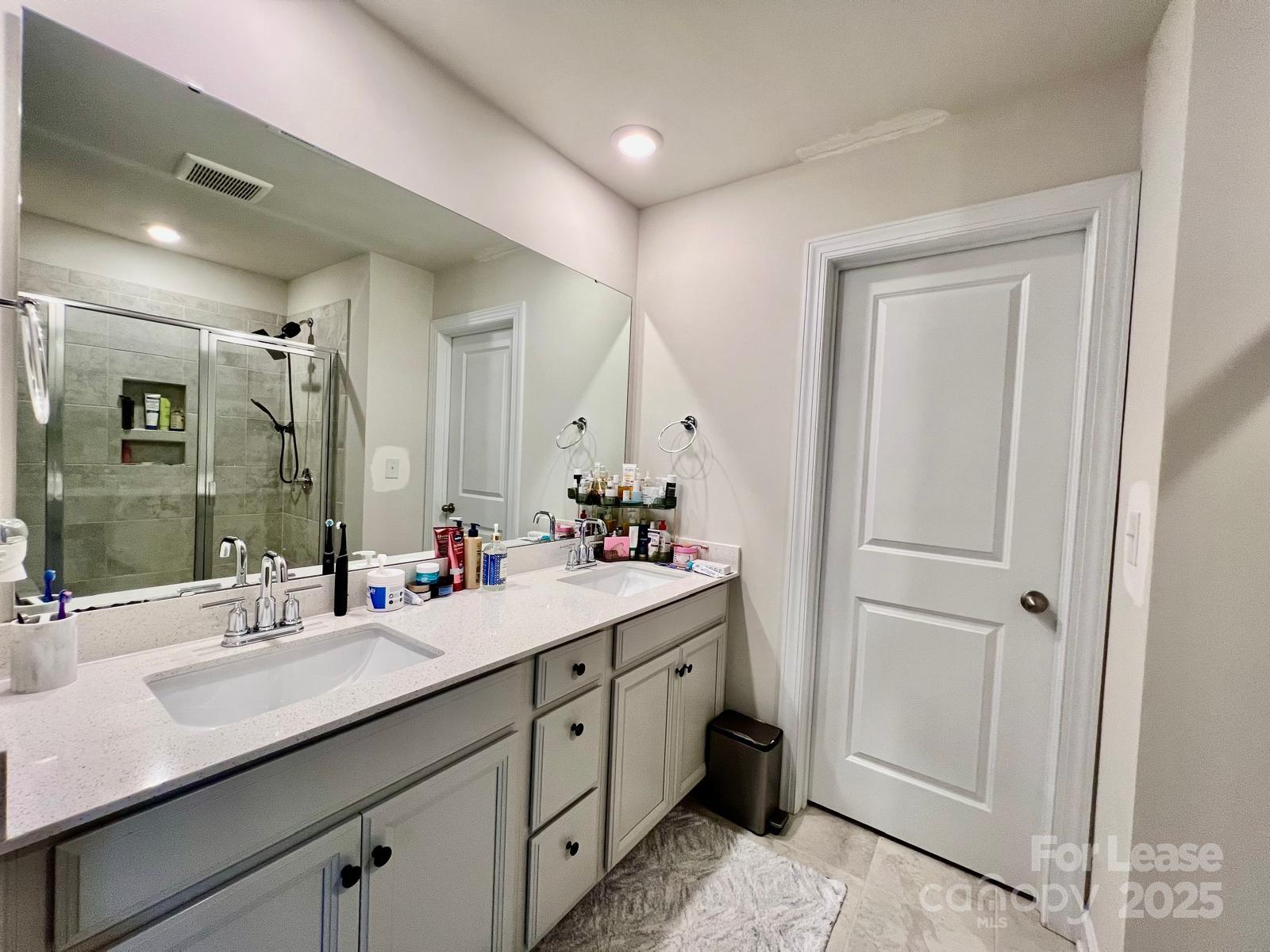 11509 Corleone Street Huntersville, NC 28078 - Photo 10 of 21 a bathroom with a double vanity sink mirror and double
