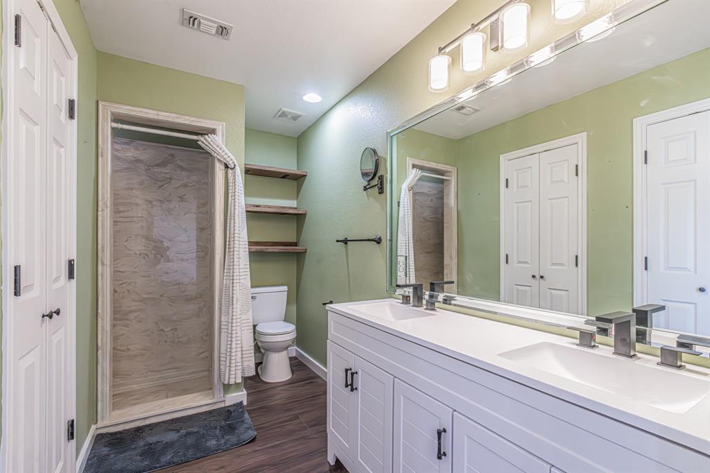 204 Spring Branch Trail South Springtown, TX 76082 - Photo 29 of 39 Dual vanity with integrated sinks and contemporary faucets, full-width mirror, and overhead vanity lighting