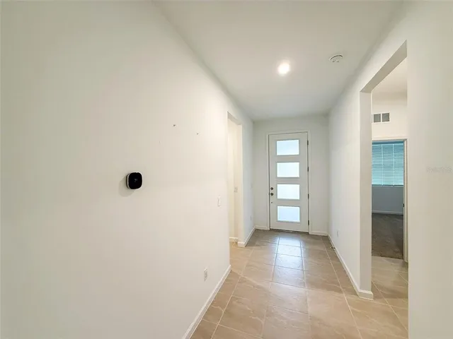 an entryway of a house with white walls