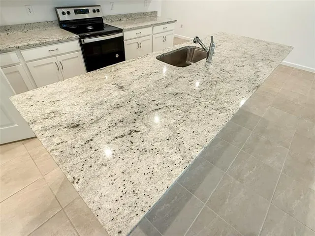 a kitchen with a stove top oven and sink