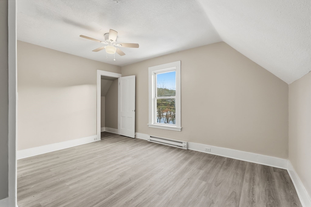 62 East Main Street Erving, MA 01344 - Photo 15 of 23 a view of an empty room with wooden floor and a window