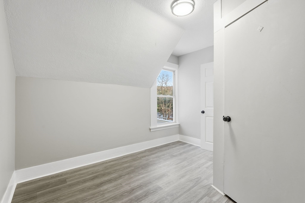 62 East Main Street Erving, MA 01344 - Photo 20 of 23 a view of an empty room with wooden floor and a window