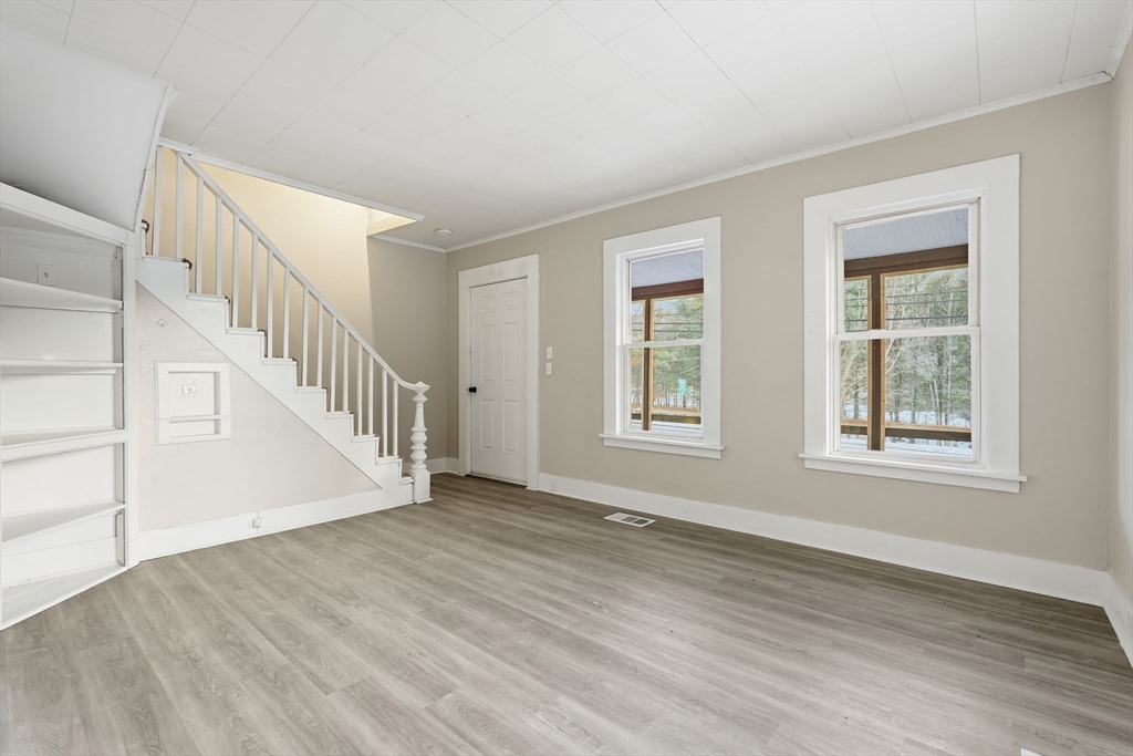 62 East Main Street Erving, MA 01344 - Photo 5 of 23 a view of an empty room with wooden floor and a window
