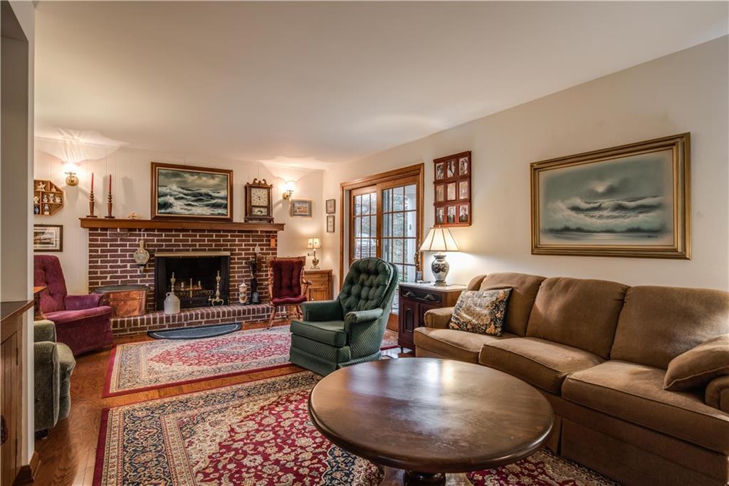 9371 Hilliard Road Pittsburgh, PA 15237 - Photo 2 of 22 THIS FAMILY ROOM FEATURES BEAUTIFUL NEWER HARDWOOD FLOORING AND BRICK FIREPLACE.