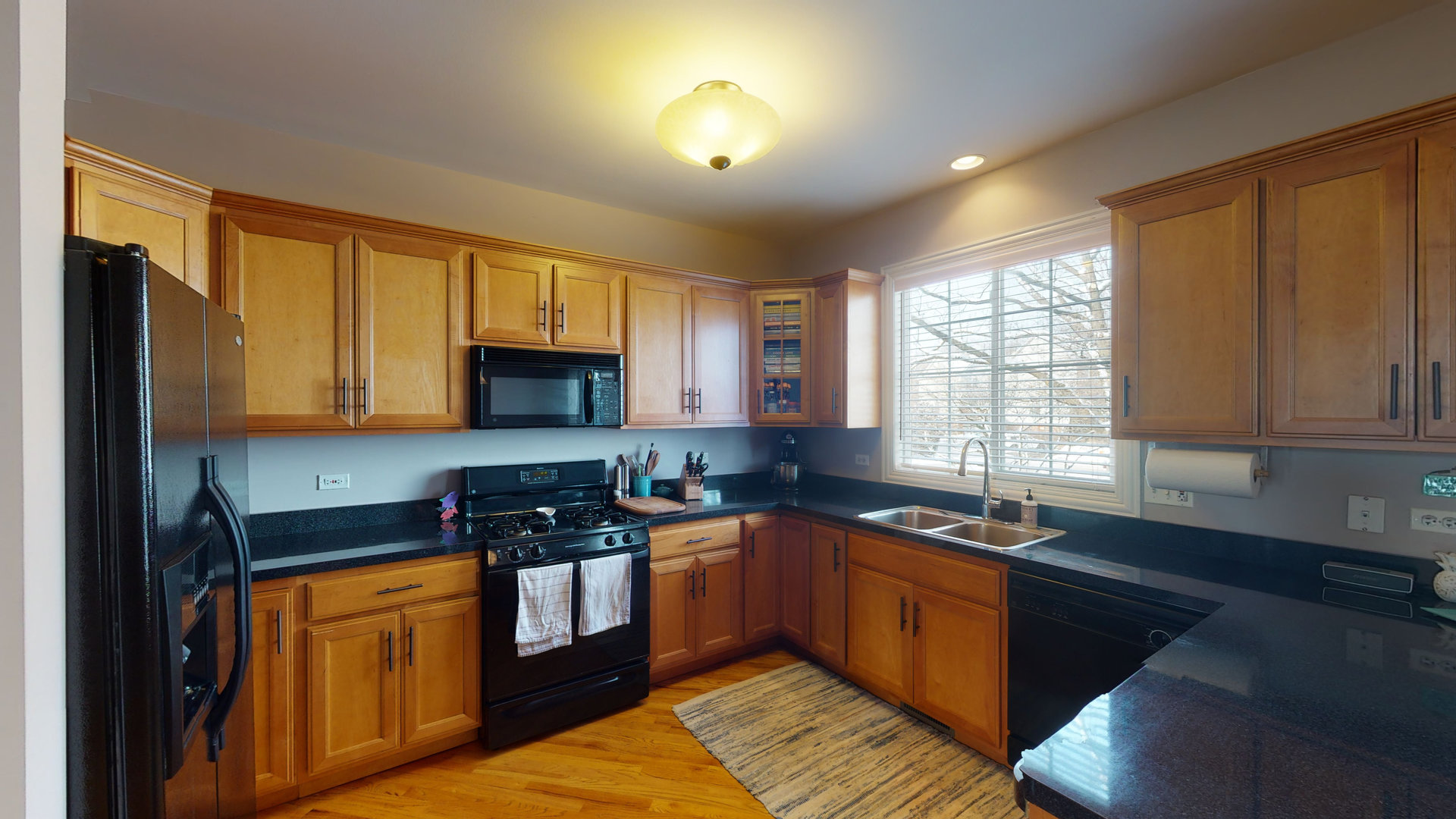 716 Prescott Court Naperville, IL 60563 - Photo 6 of 21 a kitchen with stainless steel appliances granite countertop a sink a stove cabinets counter space and a window