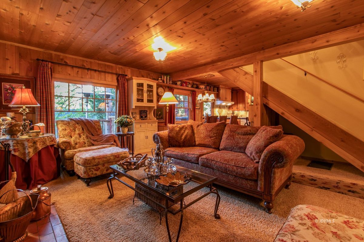 24715 Upper Rim Rock Road Idyllwild, CA 92549 - Photo 17 of 64 a living room with furniture and a large window