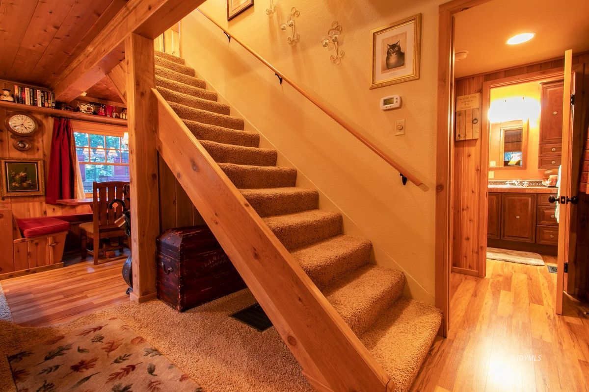 24715 Upper Rim Rock Road Idyllwild, CA 92549 - Photo 18 of 64 a view of an entryway with wooden floor and a living room