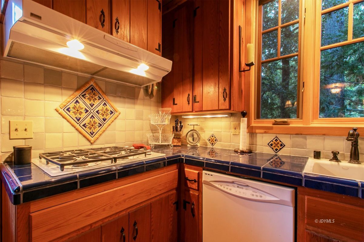 24715 Upper Rim Rock Road Idyllwild, CA 92549 - Photo 25 of 64 a kitchen with a sink and a stove top oven