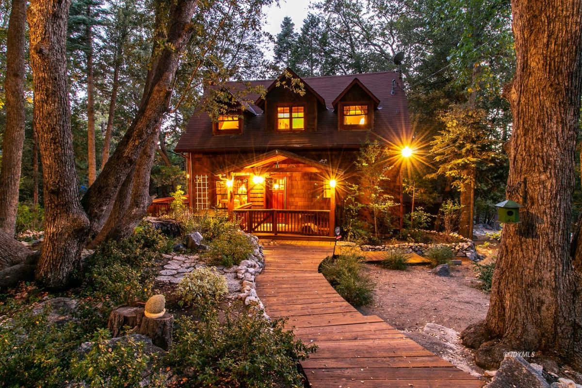 24715 Upper Rim Rock Road Idyllwild, CA 92549 - Photo 3 of 64 a view of a brick house with a yard