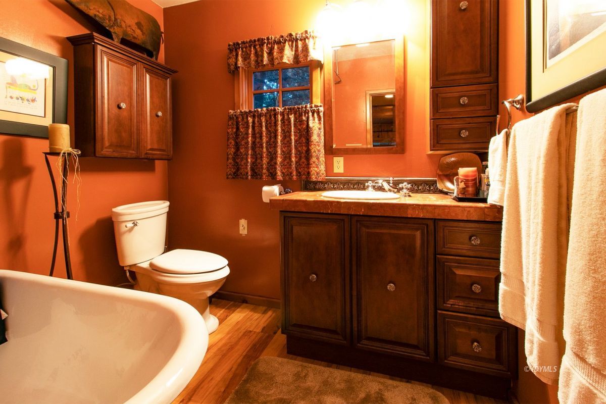 24715 Upper Rim Rock Road Idyllwild, CA 92549 - Photo 31 of 64 a bathroom with a toilet sink and mirror