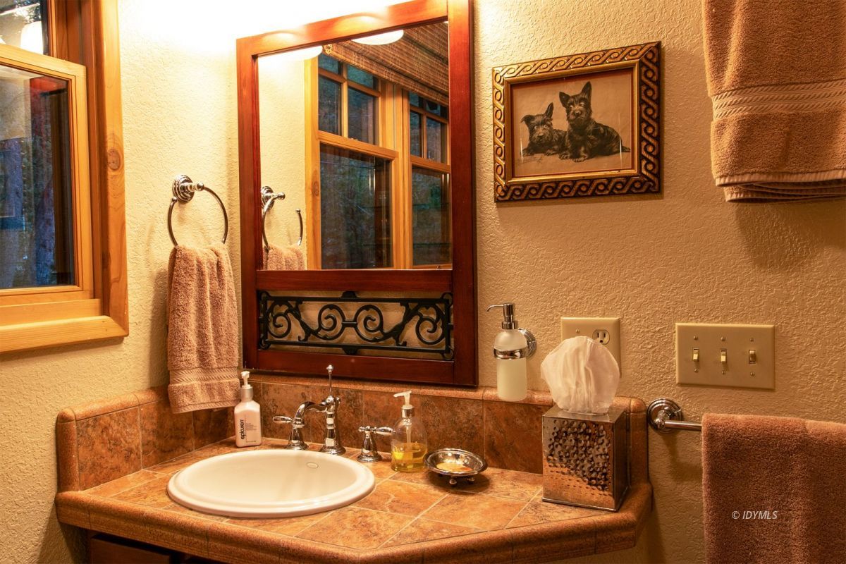 24715 Upper Rim Rock Road Idyllwild, CA 92549 - Photo 49 of 64 a bathroom with a sink mirror and vanity